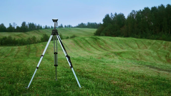 black and white tripod on green grass field during daytime